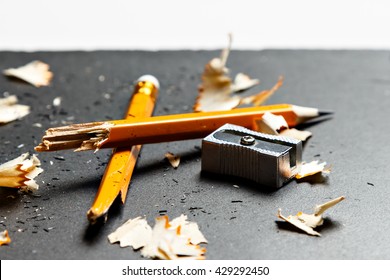 Broken pencil with metal sharpener and shavings on black background. Horizontal image. - Powered by Shutterstock