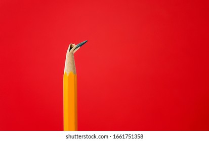 Broken Pencil Tip On Red Background.