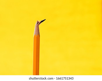 Broken Pencil Tip On Yellow Background.