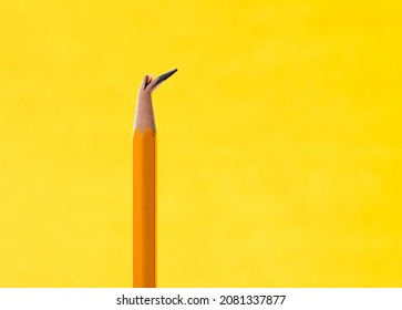 Broken Pencil Tip On Yellow Background.