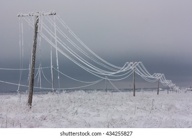 Broken Phase Electrical Power Lines With Hoarfrost On The Wooden Electric Poles On Countryside In The Winter,  Pole With Wires