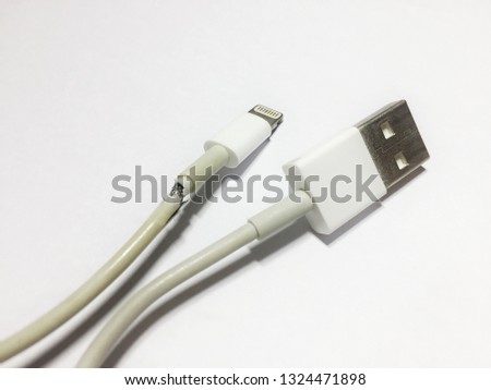 Broken phone charging cable on a white background.