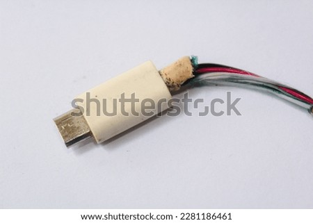 Broken phone charging cable on a white background. Closeup the Broken Smart Phone Charger Cable on white Background