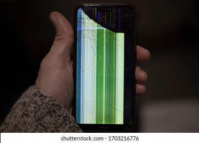 Broken phone. Damaged smartphone screen. NOISES IN THE IMAGE. Cracks on the glass of a mobile device. Repair devices.