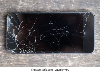 Broken phone on wooden bench