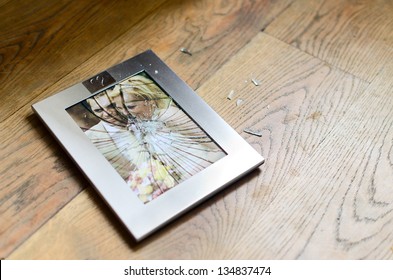 Broken photo frame of married couple ending in divorce