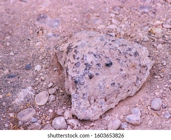 A Broken Piece Of Asphalt On The Ground Among Dirt And Stones, Del Rio, TX/USA (Jan. 1, 2020)