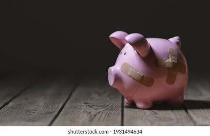 Broken piggy bank with band aid bandage or plaster finance background concept for economic recession or bankruptcy - Shutterstock ID 1931494634