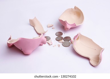 Broken Piggy Bank With Coins Isolated On White