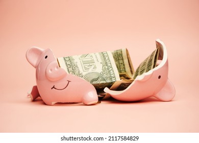 Broken piggy bank with coins money on pink background, close-up. Finance, saving money for travel - Powered by Shutterstock