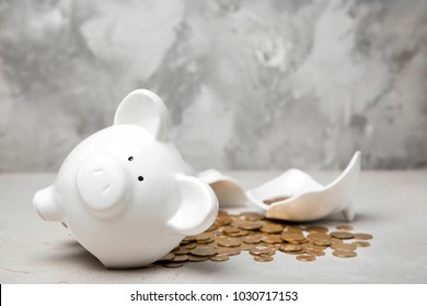 Broken Piggy Bank With Money On Table