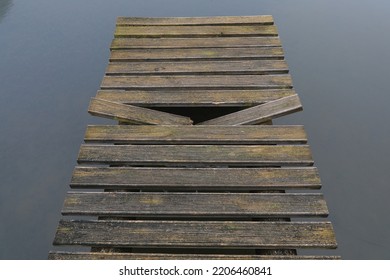 Broken Plank In Bridge With Calm Water Background