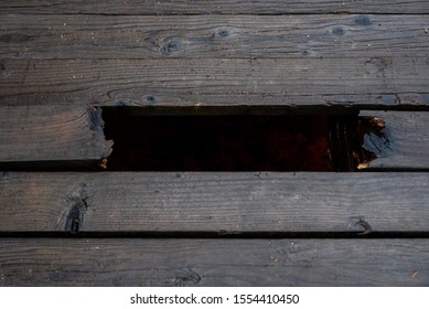 Broken Plank On A Wooden Foot Bridge.