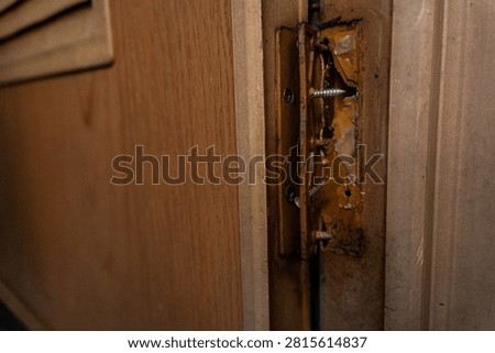Broken plastic door hinge with severe damage, making it unsuitable for further use.