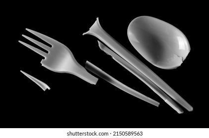 Broken Plastic White Fork And Spoon, Pieces Isolated On Black  