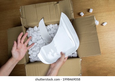 Broken Plate In Damaged Cardboard Box Top View, Damaged Home Delivery Unpacking Box Close Up