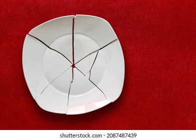Broken Plate. White Shards, splinters of a shattered Plate. Fragments of a white tableware. Shards and pieces of a broken dish