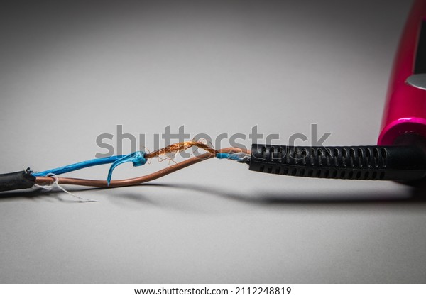 Broken power cord for home electrical\
appliances. Mechanically damaged electrical\
cable.