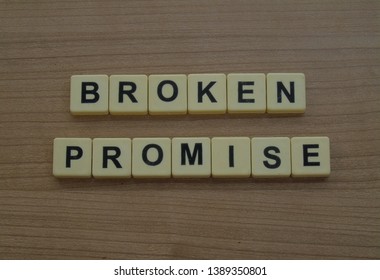 Broken Promise Word Cube On Wood Background