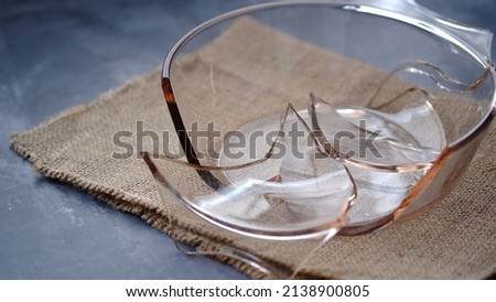 Broken pyrex dish on a table.
