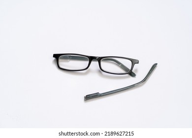 Broken Reading Glasses On White Background