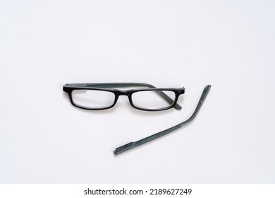 Broken Reading Glasses On White Background