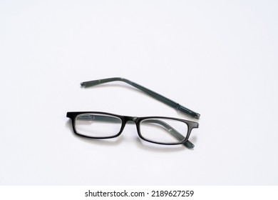 Broken Reading Glasses On White Background