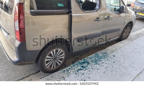 Broken\
rear side window of a car by thief with broken glass on the floor.\
Car thief, insurance, alarm protection\
concepts