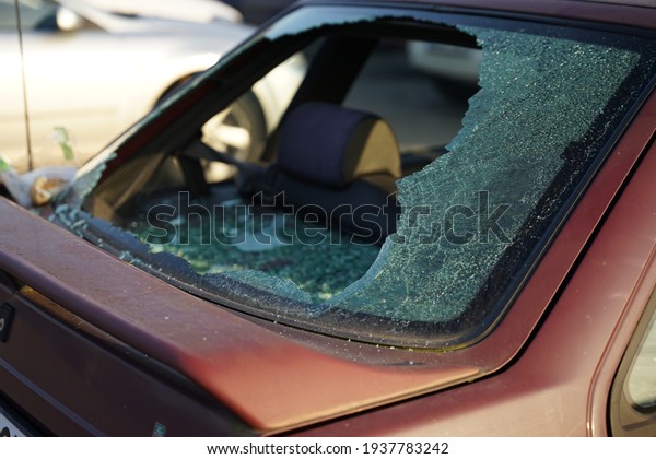 Broken rear window in car, thief smashed window\
and stole valuable items\
concept