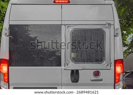 Broken Rear Window Covered With Plastic and Tape at Campervan