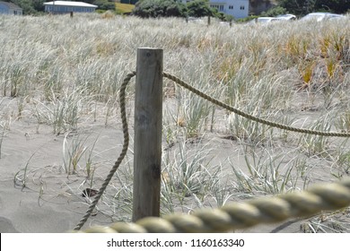 Broken Rope At The End Of The Bridge On The Beach Of New Zealand