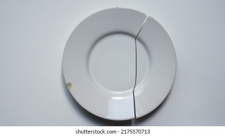 Broken Round White Plate On White Background. Crockery. Reparation Of Ceramic Dinnerware. - 3 June 2022, Montreal, Canada