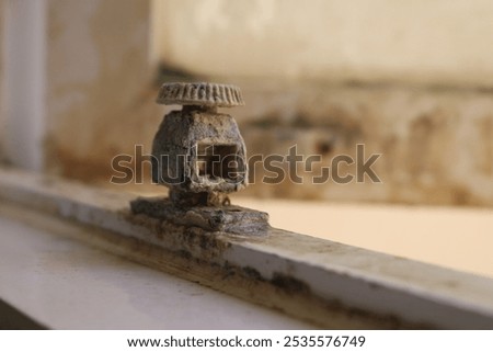 broken and rusty window stopper