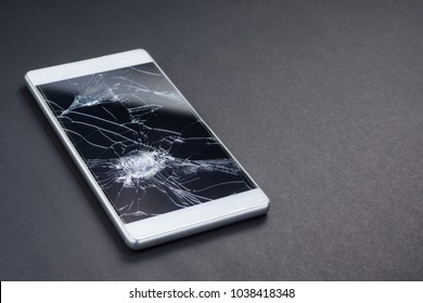 Broken Screen Cellphone (smartphone Or Mobilephone) On Dark Texture Background