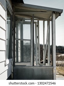 Broken Screen Door On An Abandoned Building