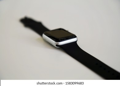 Broken Series 3 Apple Watch with broken screen partially unattached to the body of the watch. Trendy smartwatch in silver color with black band. White background. Helsinki, Finland, August 2019.