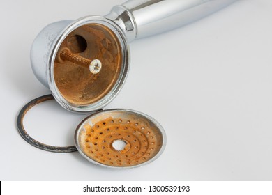 Broken Shower Head With Limescale And Rust On It