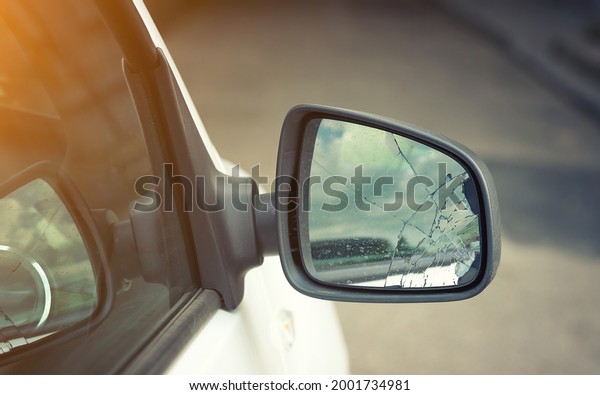 Broken side door wing mirror. Damaged car side mirror, cracked glass ...