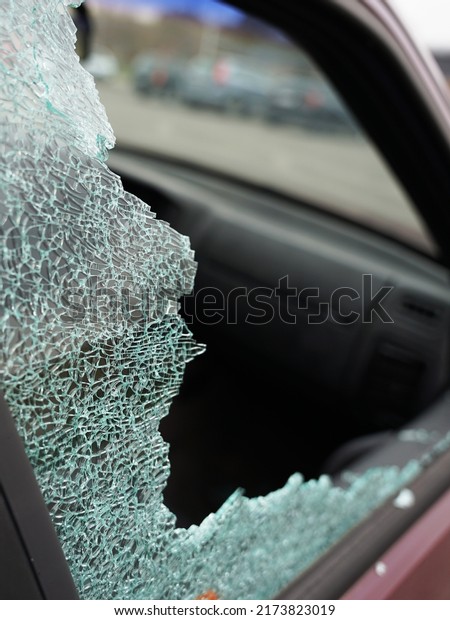 Broken side window in car by burglar to
get valuables, robbery or driving accident
concept