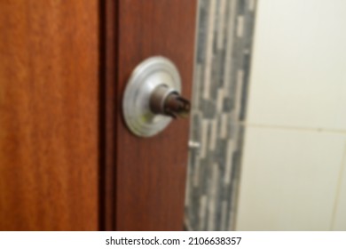 Broken Silver Doorknob. Blurred Background.