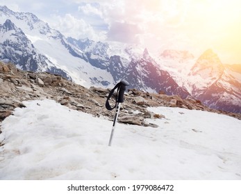 A Broken Ski Pole Stands In The Snow Against The Snow-capped Mountains Of Elbrus. Ski Sports Resort. The Concept Of Injury, Damage, Missing While Climbing. Rescue And Search In The Mountain.