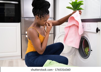 Broken Smelly Washing Machine. Woman Washing Towel