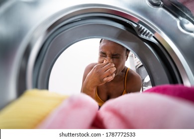 Broken Smelly Washing Machine. Woman Washing Towel