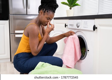 Broken Smelly Washing Machine. Woman Washing Towel