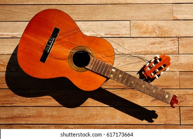 Broken Spanish Guitar Neck On The Wooden Deck Floor