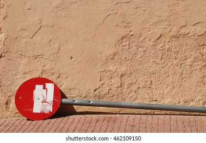 Broken Stop Sign On The Sidewalk.