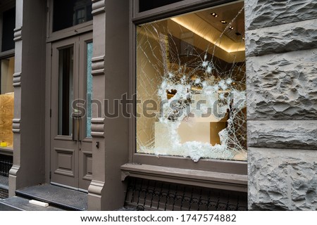 Broken store window by vandals