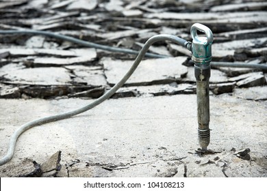 Broken Street Asphalt With Jackhammer Pneumatic Paving Breaker Drill At Road Pavement Repairing Work