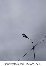 broken street lamp and cloudy sky - Shutterstock ID 2257987743