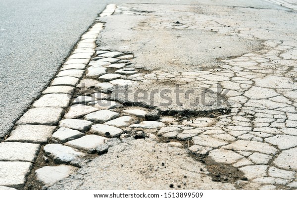 Broken street surface texture with street stones
and asphalt